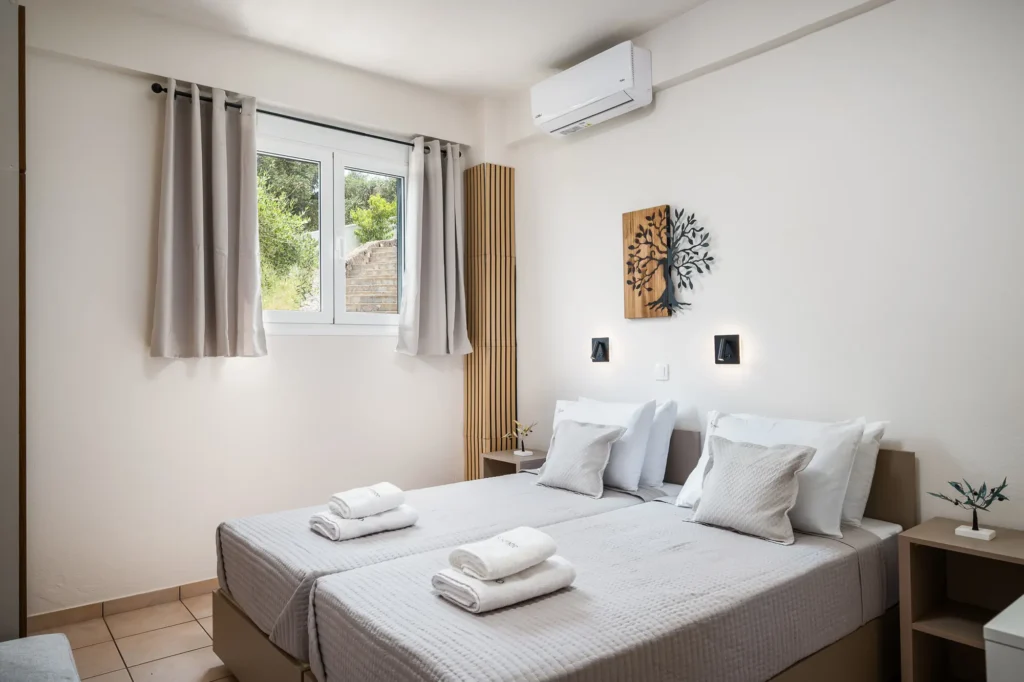 Bedroom with double bed and natural light at Apovrado Stay in Corfu