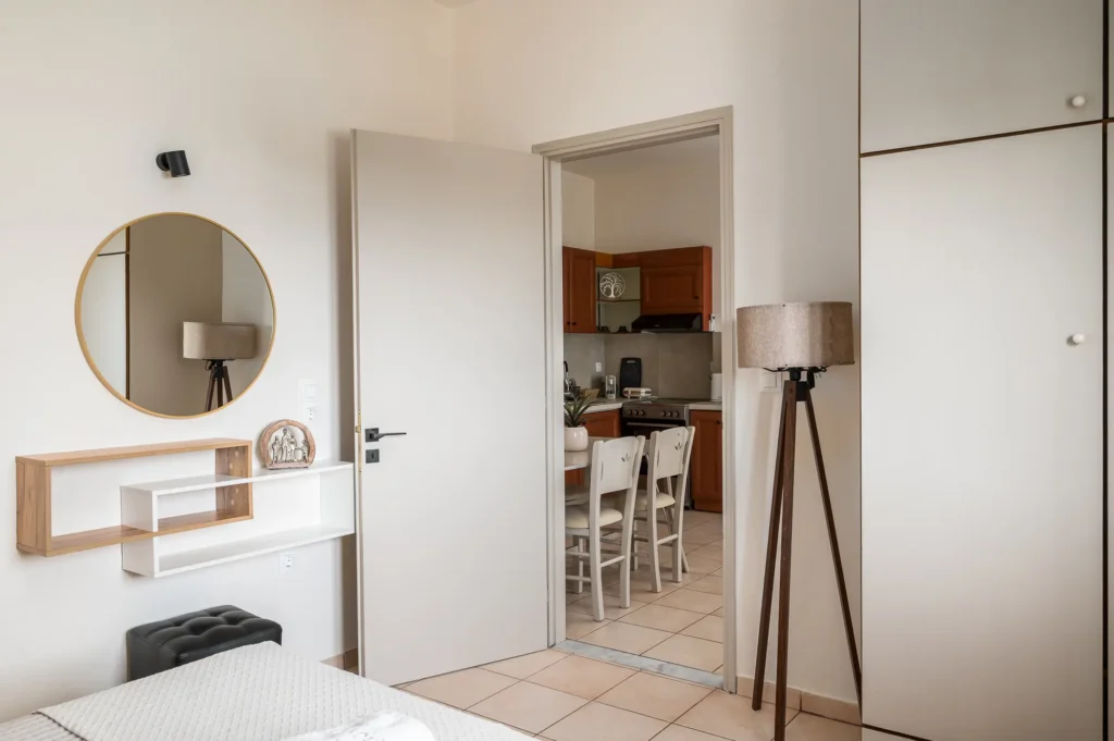 Apartment interior with bedroom area and kitchenette at Apovrado Stay Corfu